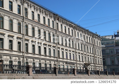 A stunning historical building facade set against a bright blue sky, showcasing its beauty 126654170