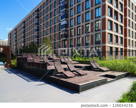 A modern urban relaxation space with comfortable loungers for ultimate leisure and enjoyment A modern urban relaxation space with comfortable loungers for ultimate leisure and enjoyment 126654238