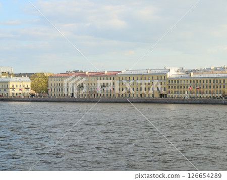 Explore the charming waterfront buildings along the river, attracting tourists and locals Explore the charming waterfront buildings along the river, attracting tourists and locals 126654289