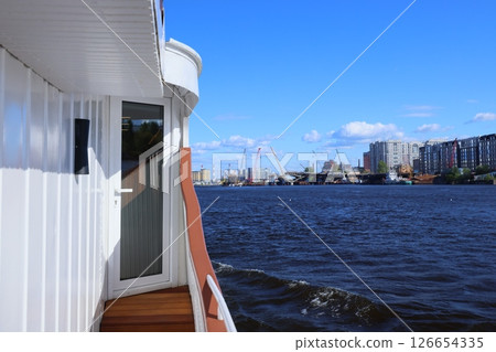Experience the Serene and Beautiful River View from a Boat with an Urban Background Experience the Serene and Beautiful River View from a Boat with an Urban Background 126654335
