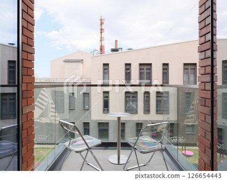 A Beautiful Modern Balcony View Overviewing a Lively Urban Landscape Full of Life and Color 126654443