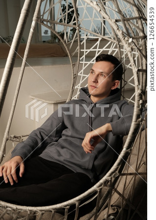 Enjoy modern relaxation in a uniquely designed hammock setting that provides tranquility Enjoy modern relaxation in a uniquely designed hammock setting that provides tranquility 126654539