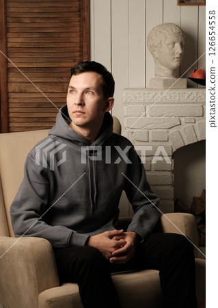 A Thoughtful Individual Dressed in Casual Attire with an Artistic Background and Vibe 126654558