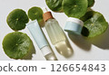 Aerial view of Centella asiatica leaves and three skin care products (beauty/cosmetics) 126654843