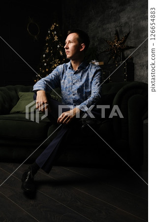 A Contemplative Portrait Featuring a Person Relaxing on a Couch in a Modern Setting 126654883