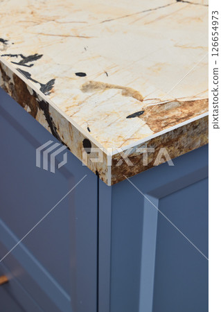 This is a stylish kitchen countertop featuring a unique edge design that stands out elegantly This is a stylish kitchen countertop featuring a unique edge design that stands out elegantly 126654973