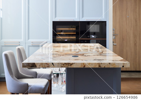 The Modern Kitchen Island with an Elegant Granite Countertop enhances any culinary space 126654986