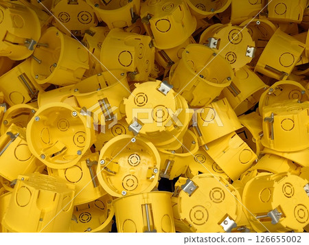 installation yellow electrical boxes use in construction projects across various sites. closeup. 126655002