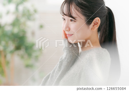 Profile of a woman doing skin care Profile of a woman doing skin care 126655084