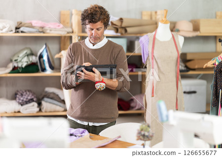 Male fashion designer drawing on tablet Male fashion designer drawing on tablet 126655677