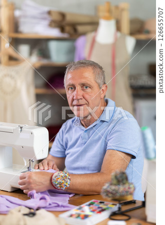 Mature man tailor sewing in workshop 126655707