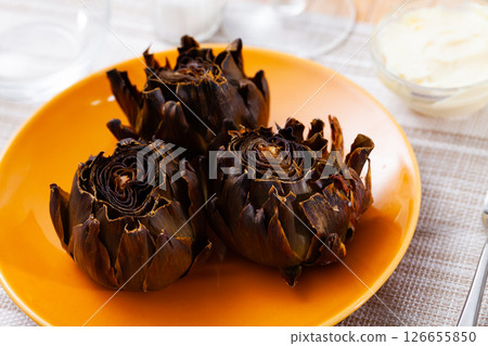 Delicious roasted artichokes served with garlic aioli sauce Delicious roasted artichokes served with garlic aioli sauce 126655850