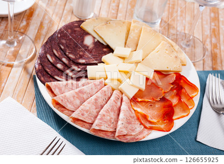 Slicing of smoked sausage, ham, dried pork carbonade and cheese Slicing of smoked sausage, ham, dried pork carbonade and cheese 126655925