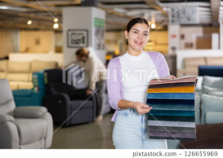 Portrait of woman presenting upholstery samples 126655969