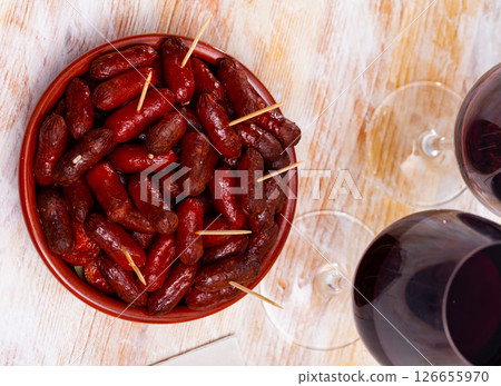 Spanish appetizer, warm mini chorizo sausages 126655970