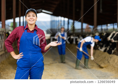 Portrait of young female farmer smiling at camera during work on farm 126656049