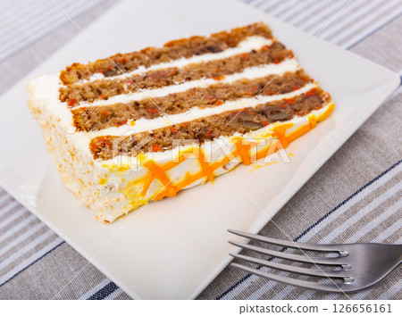 Small triangular piece of carrot cake is on plate Small triangular piece of carrot cake is on plate 126656161