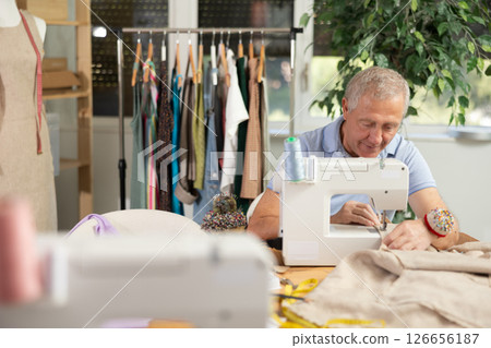 Mature man tailor sewing in workshop 126656187