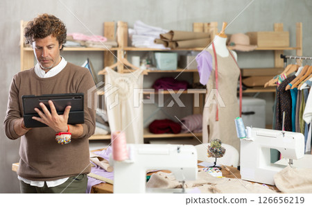 Male fashion designer drawing on tablet Male fashion designer drawing on tablet 126656219