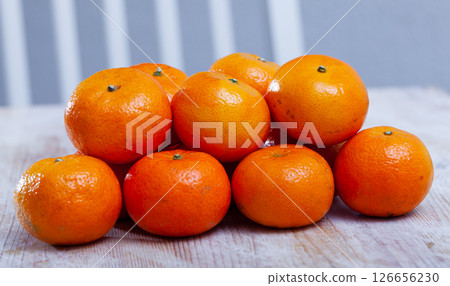 Closeup of fresh sweet clementines on wooden table 126656230