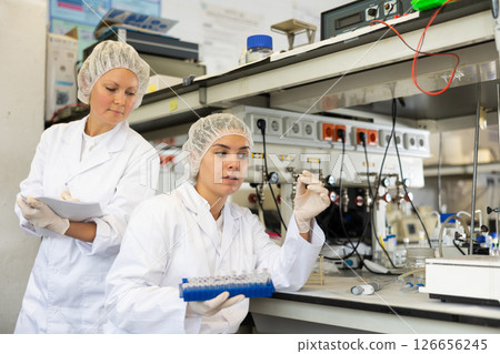 Confident women technicians working in research laboratory Confident women technicians working in research laboratory 126656245
