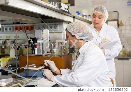 Man and woman scientists chemists conduct experiments in the laboratory 126656292