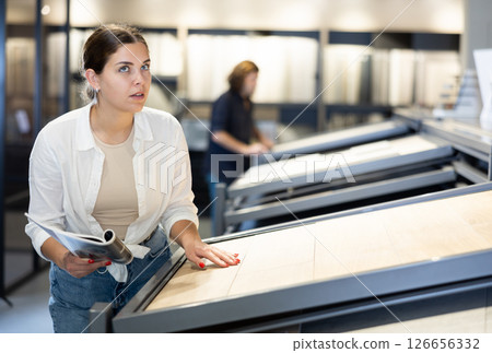 Female customer choosing kitchen ceramic tile in shop Female customer choosing kitchen ceramic tile in shop 126656332