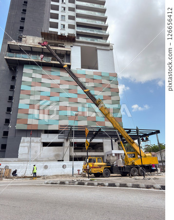Construction work on modern building with crane in Penang, Malaysia 126656412