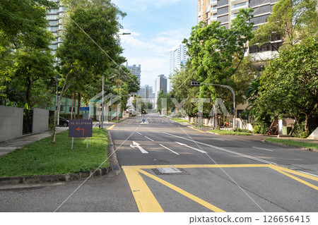 Orchard Road street view with lush greenery and urban skyline backdrop 126656415