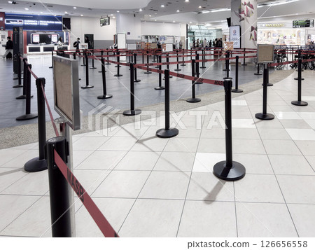 Long queue barriers arranged for orderly waiting at a pass control in Penang airport 126656558