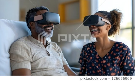 Couple experiences virtual reality together sharing joyful moments at home 126656969