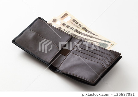 A bi-fold wallet with money inside 126657081