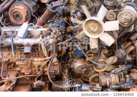 Rusty Engines and Various Mechanical Parts Found in a Scrap Yard Full of Discarded Items 126658408