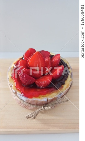 Rich and creamy burnt cheesecake with a perfectly caramelized top, crowned with fresh fruits for a delightful burst of flavor and texture in every bite. Rich and creamy burnt cheesecake with a perfectly caramelized top, crowned with fresh fruits for a delightful burst of flavor and texture in every bite. 126658481