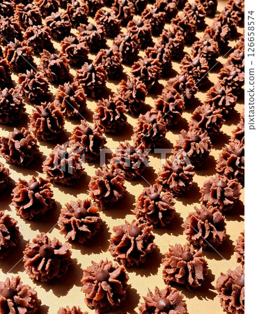 Delicate and crispy chocolate kue semprit with a rich cocoa flavor, beautifully shaped with a swirl pattern. A classic Indonesian cookie perfect for snacking or festive celebrations. Delicate and crispy chocolate kue semprit with a rich cocoa flavor, beautifully shaped with a swirl pattern. A classic Indonesian cookie perfect for snacking or festive celebrations. 126658574