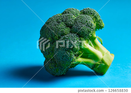 tempting broccoli in the industrial corner on a pastel blue background 126658830