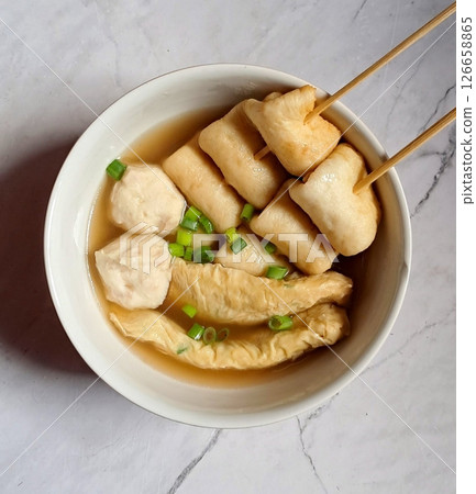 Odeng, a popular Korean street food made from seasoned fish cake, skewered and served in a warm, savory broth. Often paired with dipping sauces, it's a comforting and flavorful snack enjoyed anytime. Odeng, a popular Korean street food made from seasoned fish cake, skewered and served in a warm, savory broth. Often paired with dipping sauces, it's a comforting and flavorful snack enjoyed anytime. 126658865