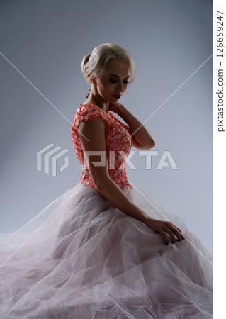 Bride in blood-stained gown poses dramatically in a studio setting Bride in blood-stained gown poses dramatically in a studio setting 126659247