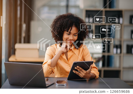 Asian woman typing smartphone, keyboard  with laptop computer of Social media and Marketing virtual icons screen concept. 126659686