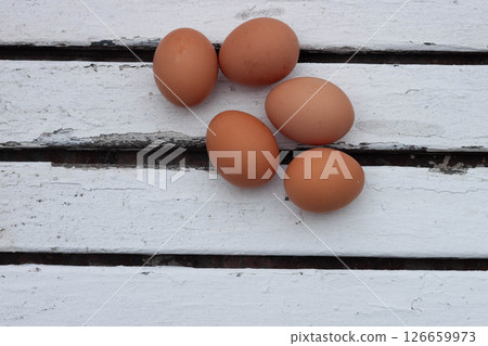 Five brown eggs on white rustic table 126659973