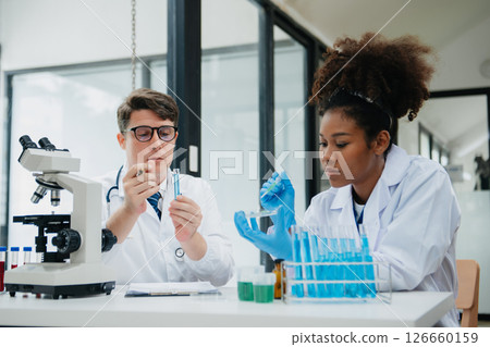 Scientist two man and woman with tablet and laptop, laboratory and ecofriendly science. Agriculture, research and scientists with online reading, test samples for global warming, analytics and tech. 126660159