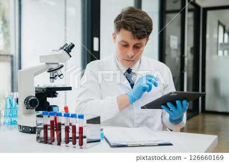 Male scientist researcher conducting an experiment in a laboratory. 126660169