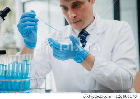 Male scientist researcher conducting an experiment in a laboratory. 126660170