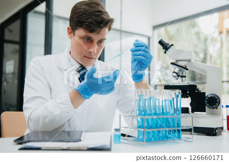 Male scientist researcher conducting an experiment in a laboratory. 126660171