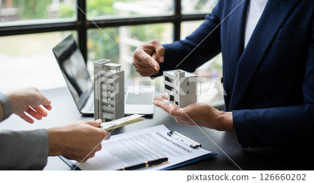 Signing a contract. Client and broker agent, lease agreement, successful deal and  Young business sitting at the desk in office 126660202