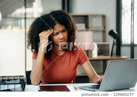 Business woman is stressed, bored, and overthinking from working on a tablet at office. Business woman is stressed, bored, and overthinking from working on a tablet at office. 126660237