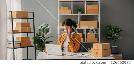 Young African woman prepare parcel box and standing check online orders for deliver to customer on tablet, laptop Shopping Online concept. 126660983
