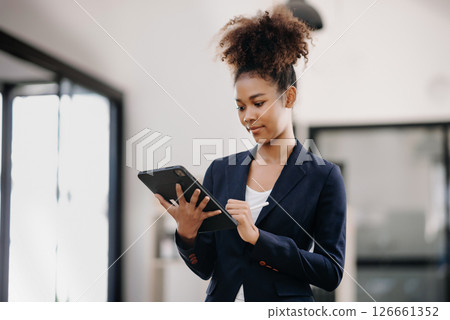 Young attractive Asian female office worker business suits smiling at camera in office 126661352