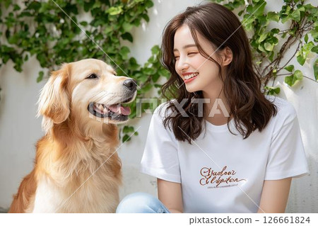 Smiling woman and golden retriever looking at each other 126661824