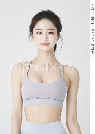 Woman is wearing a grey tank top 126662389